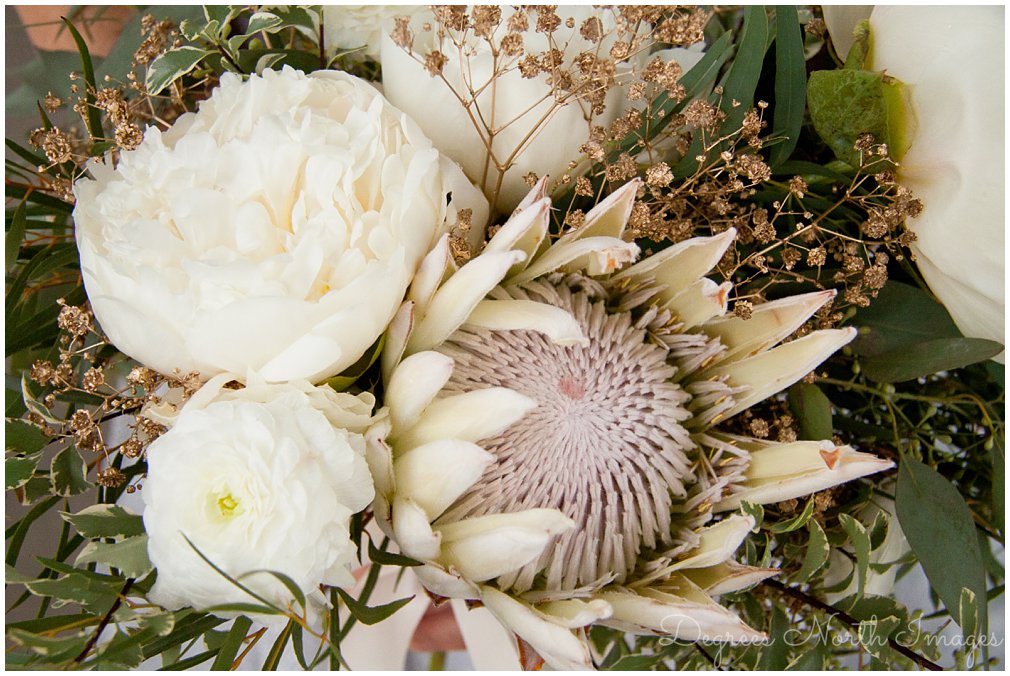 White protea and peony bridal bouquet by Flower Vibes
