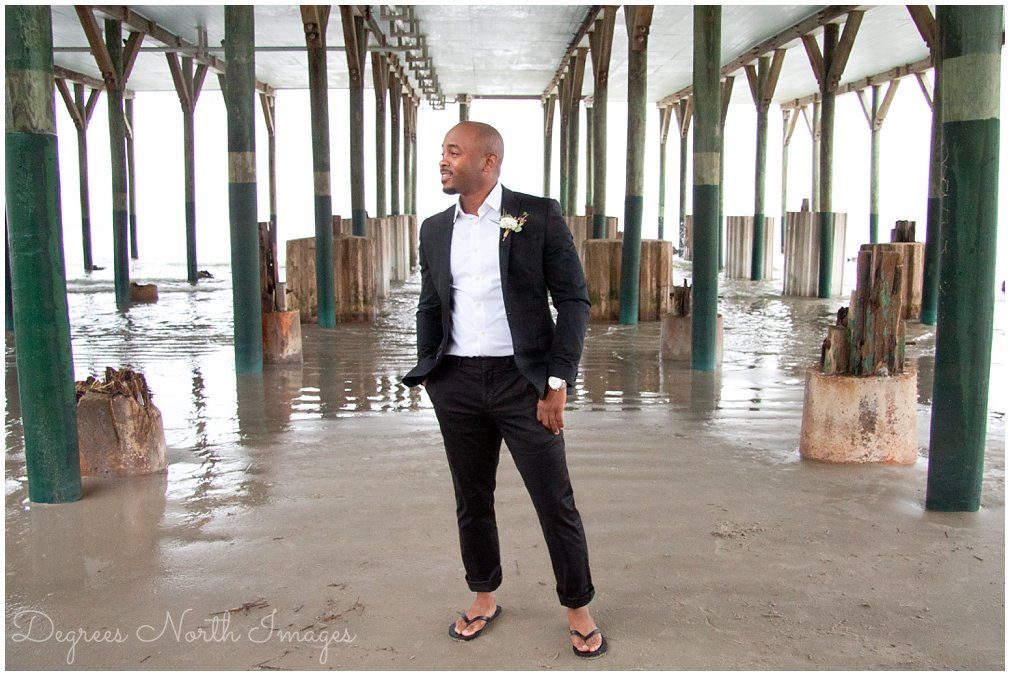Groom in black suit and flip flops at Galveston Beach elopement