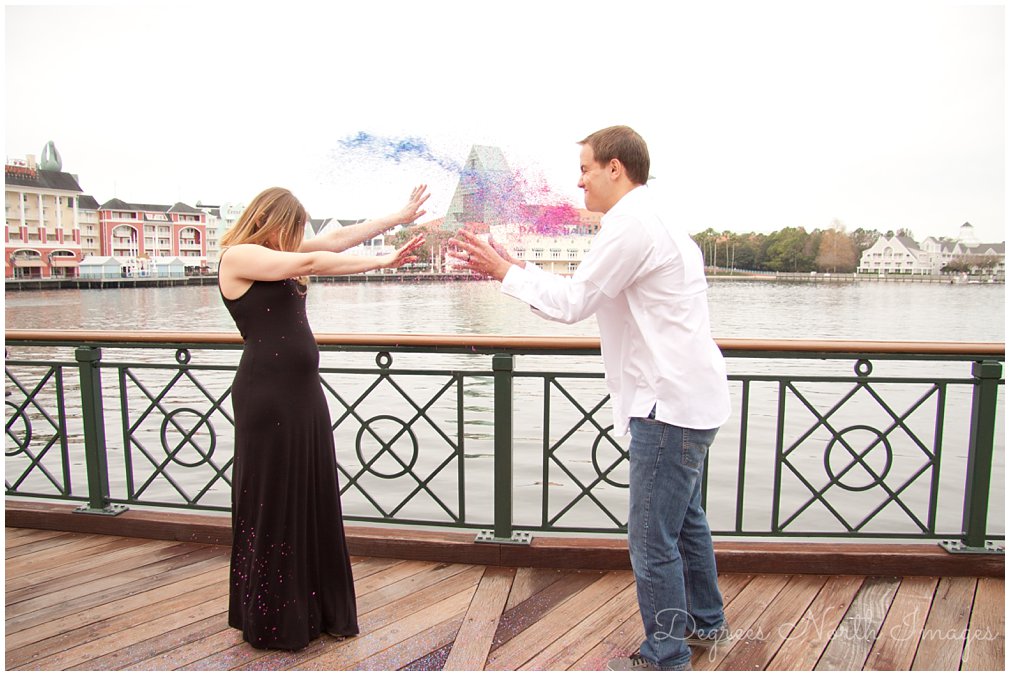 parents throwing glitter at gender reveal at Disney's Boardwalk