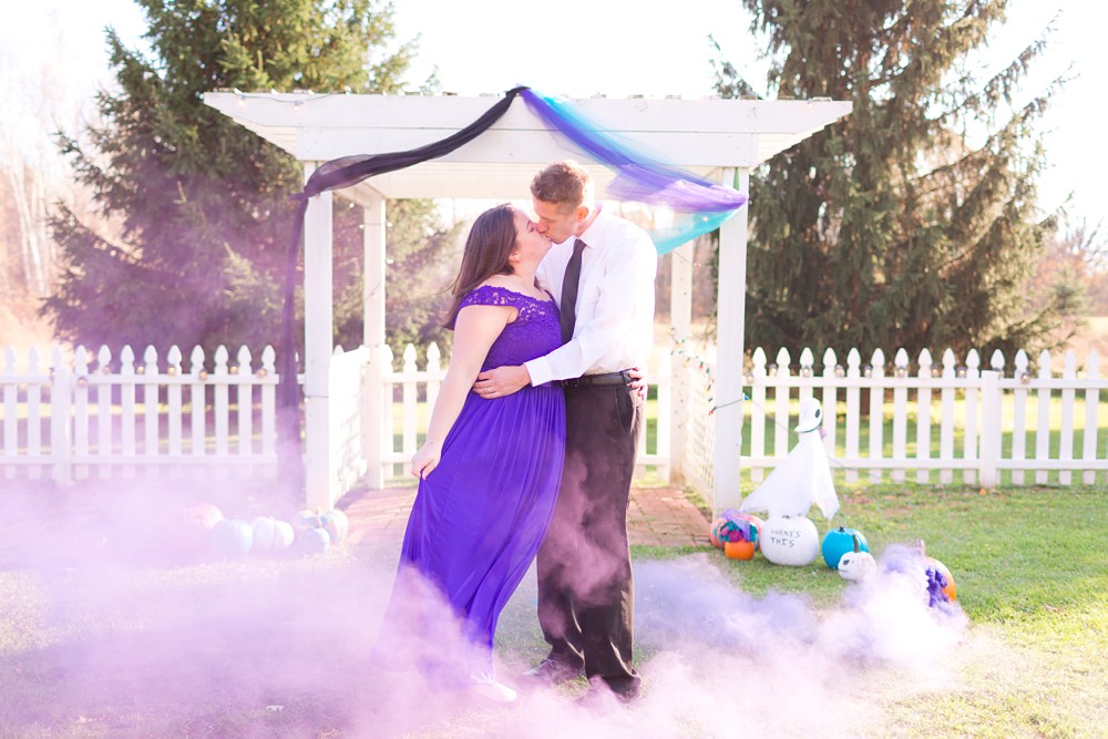 couple at Nightmare Before Christmas anniversary session with purple smoke bomb