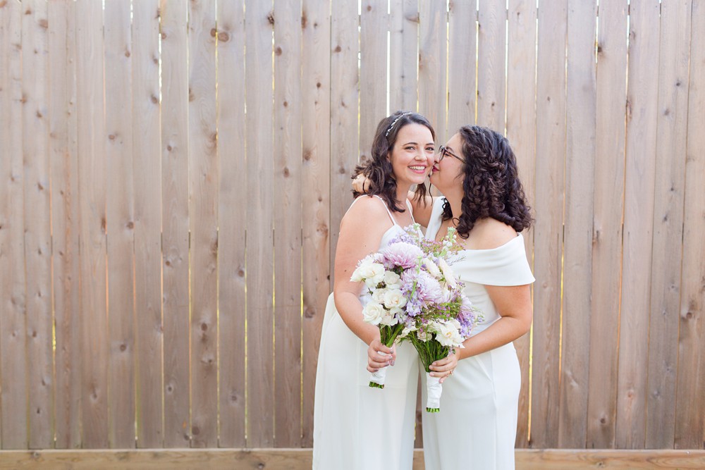 Two brides as their backyard wedding