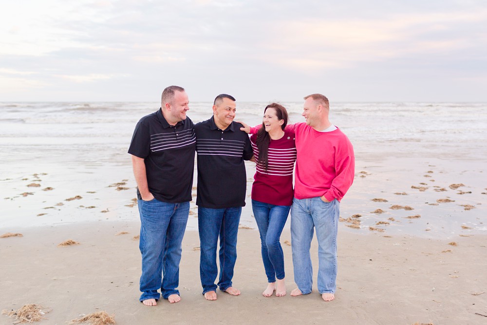 adult siblings laughing at extended family beach session in Galveston