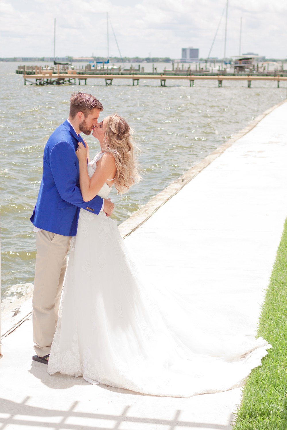 Bride and groom at Waters Edge Wedding Venue with Clear Lake in the background