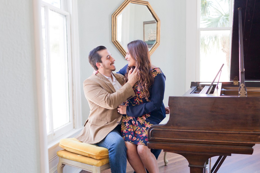 Couple playing piano at Engagement session at the Carr Mansion