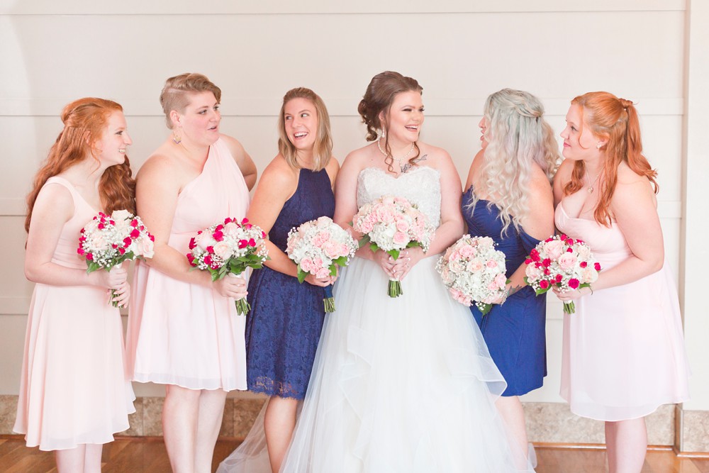 Bride laughing with maids of honor and bridesmaids