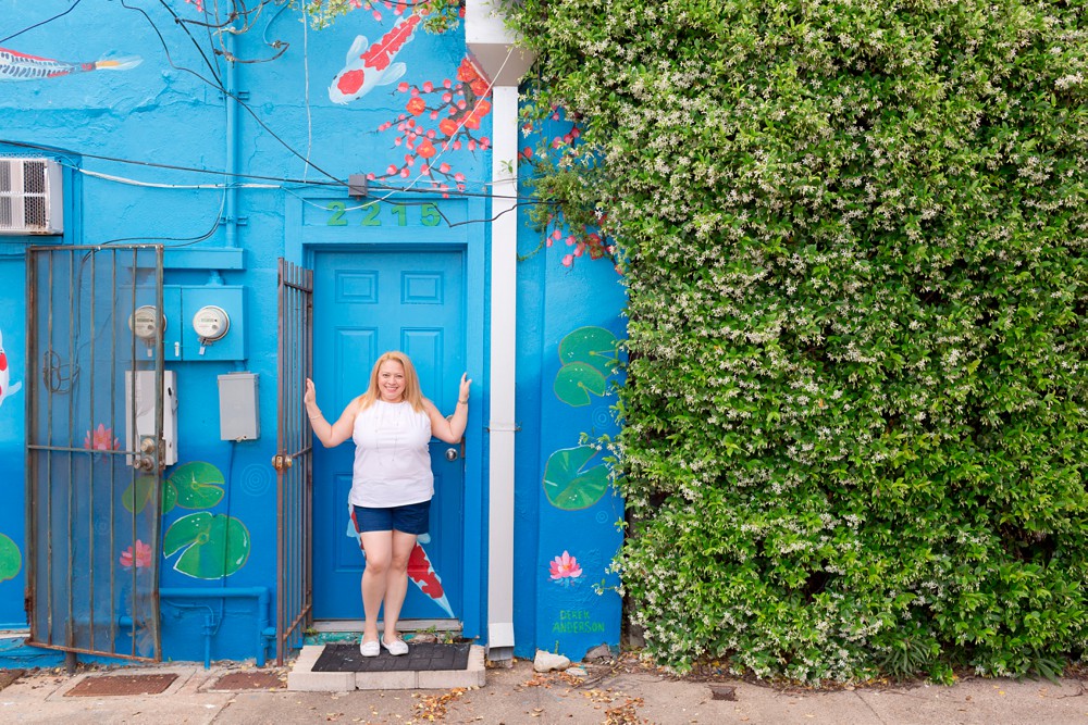 vacation portrait of a woman at the koi mural in the alley between Church and Postoffice street in Galveston