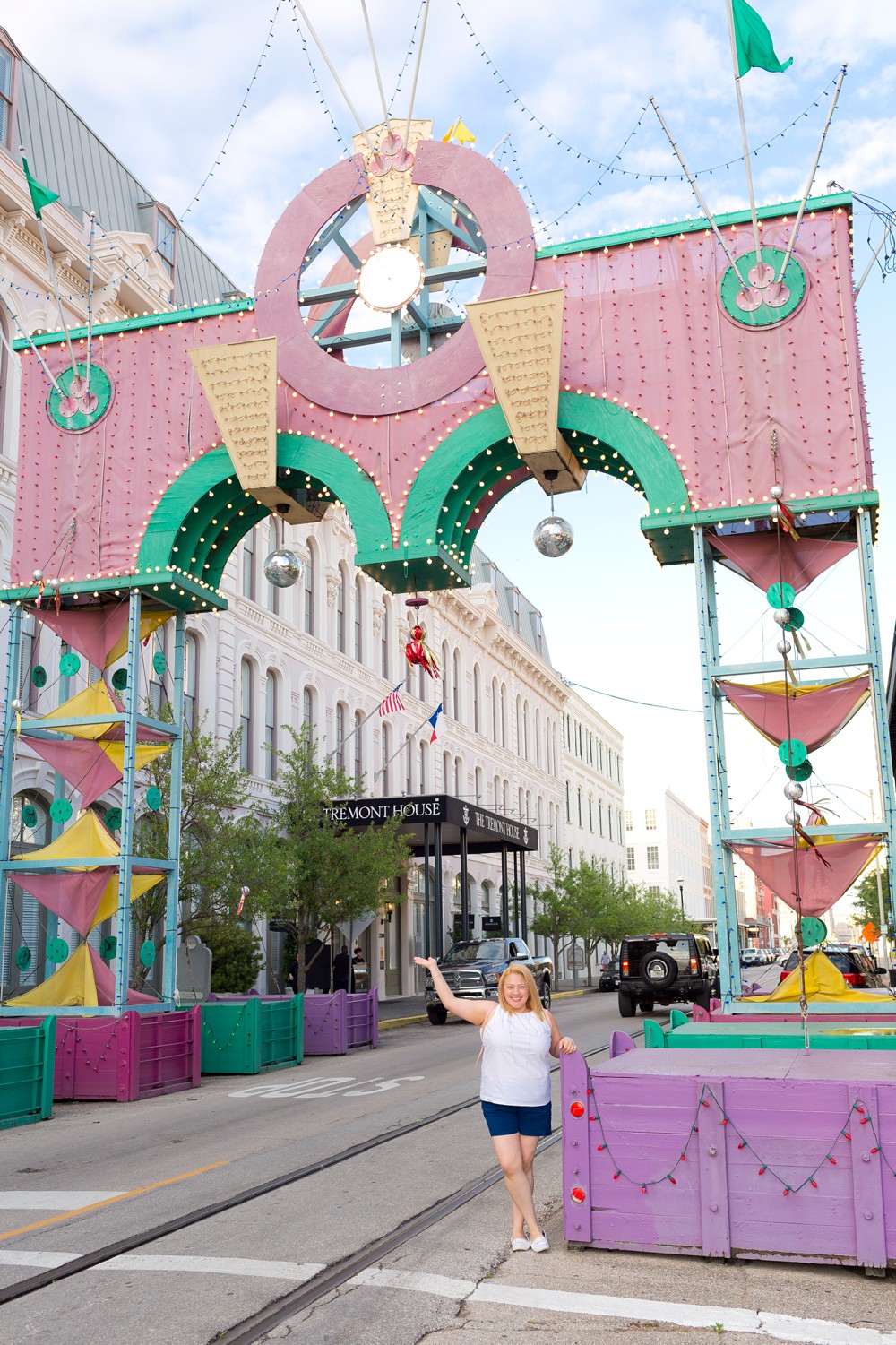 woman standing under the Mardi Gras arch near the Tremont House