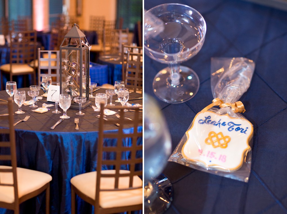 Wedding reception table with navy blue linen, iron lantern centerpiece, iron lattice chairs, personalized cookie favors