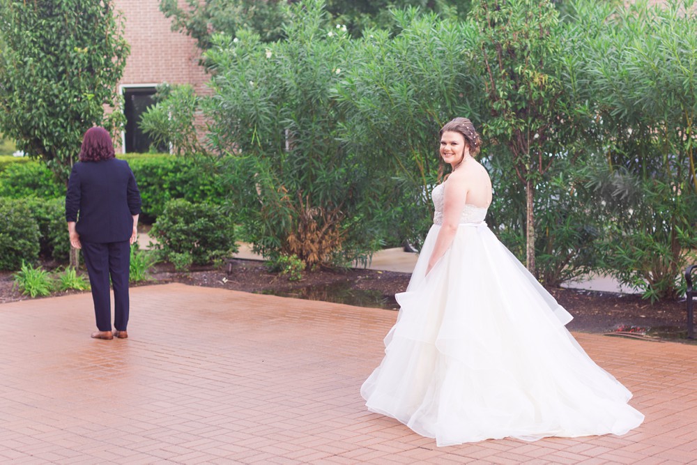 Bride and bride first look outside at Noah's Event Venue in Sugar land Texas