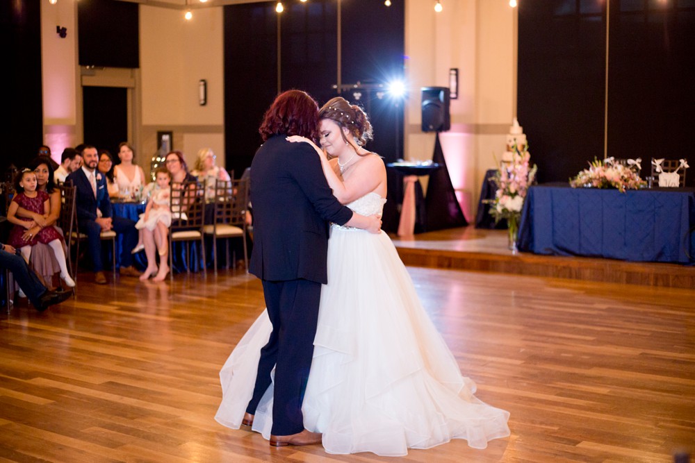 Bride and bride share their first dance at modern wedding at Noah's Event Venue