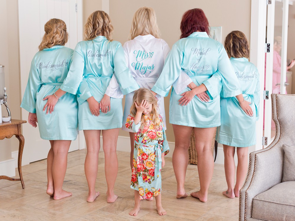 funny photo of bride and bridesmaids with flower girl at Mission Point Resort