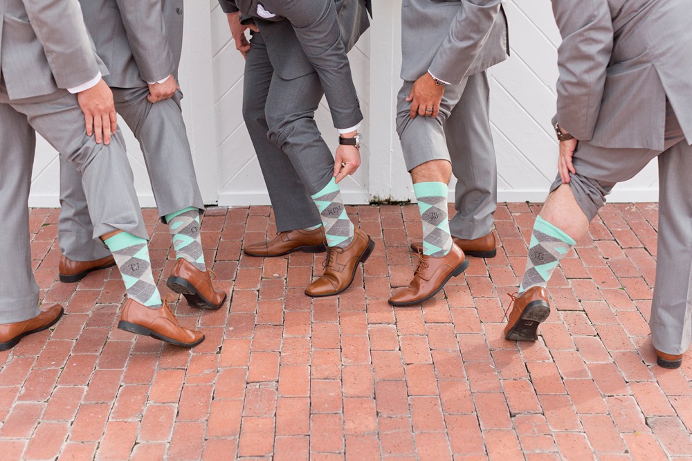 Groom and groomsmen showing off custom socks