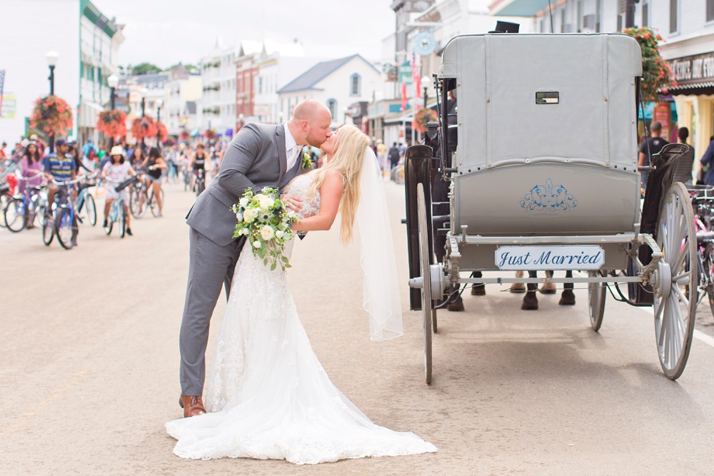 Bride and groom kissing in the middle of Main Street on Mackinac Island