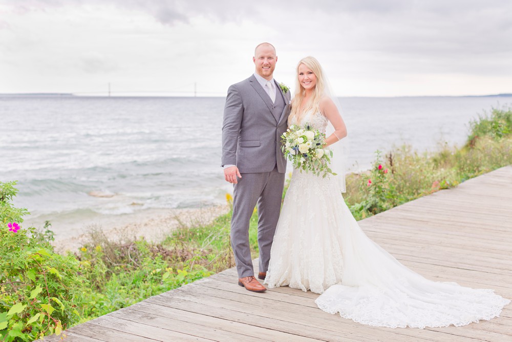Bride and groom portrait with the Mackinac Bridge in the background