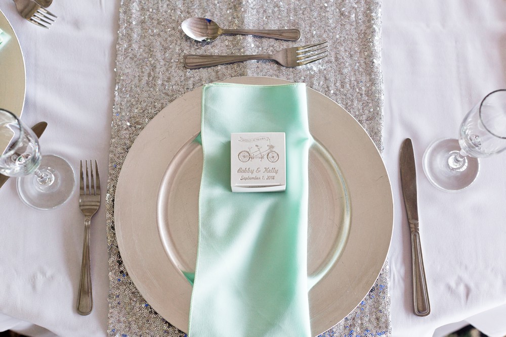 Silver and aqua wedding place setting with favor