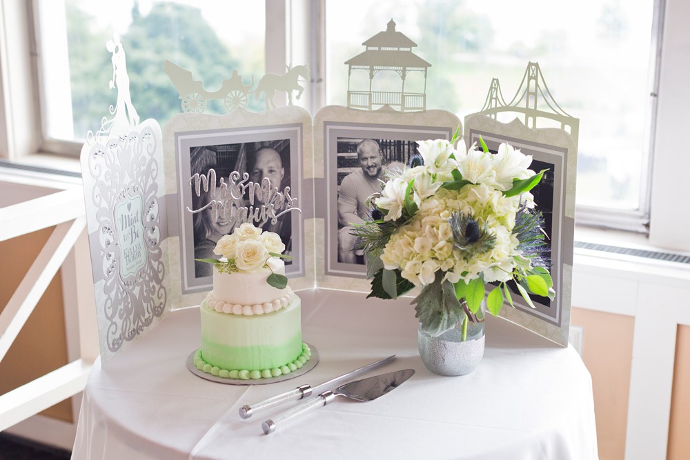 White and mint green wedding cake display in The Summit Room at Mission Point Resort
