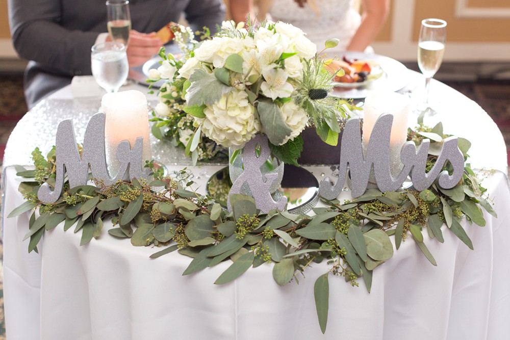 Bride and groom sweetheart table with Mr. and Mrs. signs