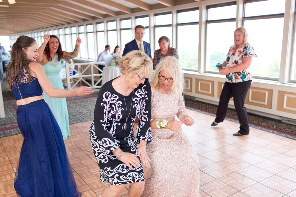 Mother of the bride dancing with sister at wedding reception