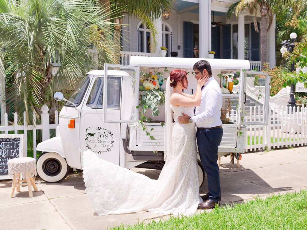 Bride and groom in front of mini mobile bar at Carr Mansion