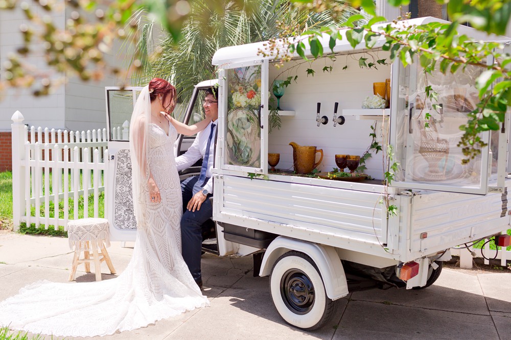 Bride and groom with mini mobile bar in Galveston