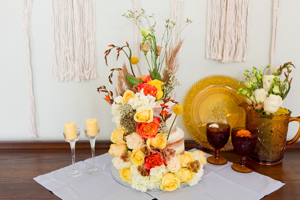Naked cake with yellow and orange flowers