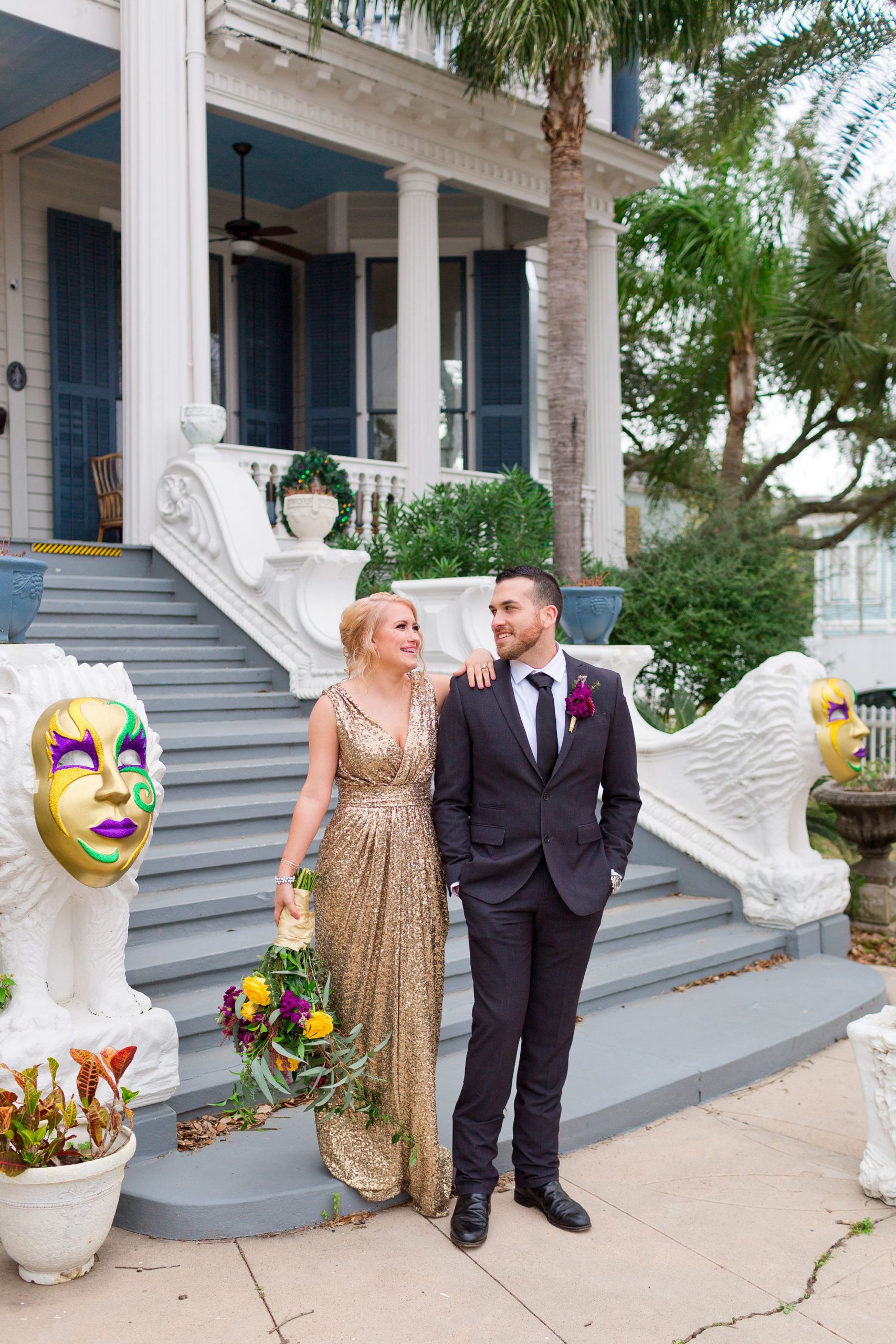 Portrait of a bride and groom on the front steps of the Carr Mansion in Galveston.
