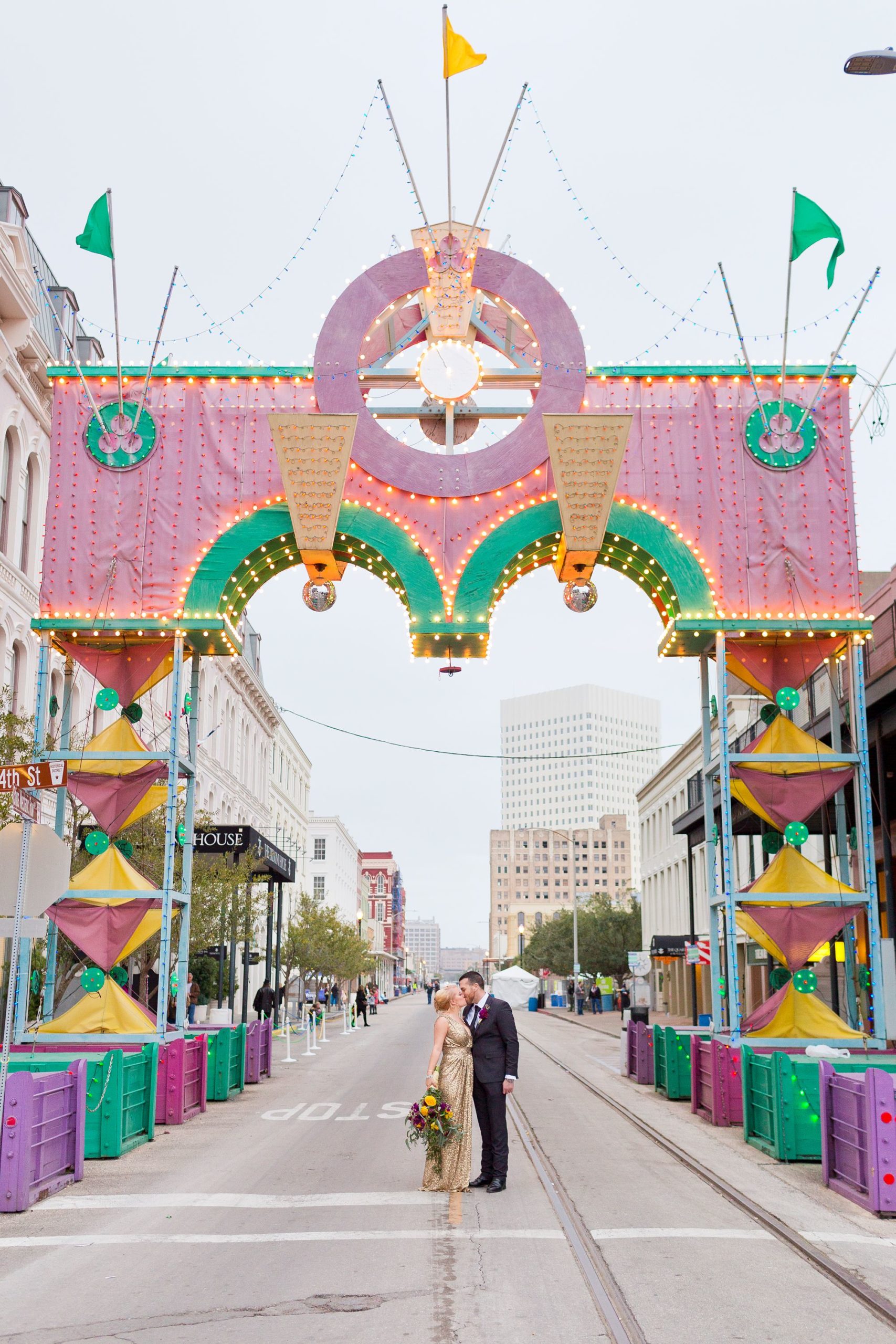 Portrait of a bride and groom under the Powell Mardi Gras Arch in Galveston, Texas.