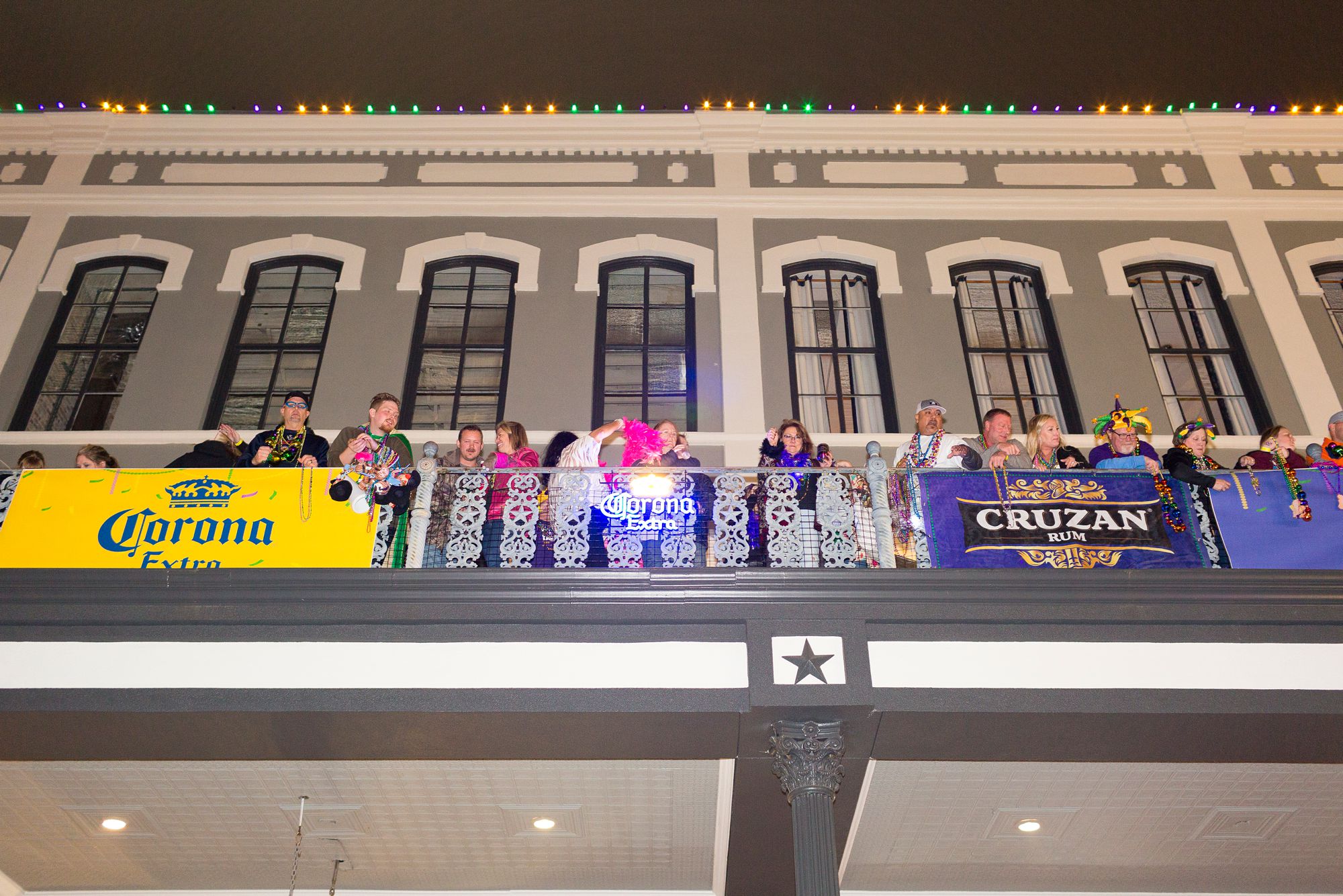 Mardi Gras Galveston balcony party with bead throwing