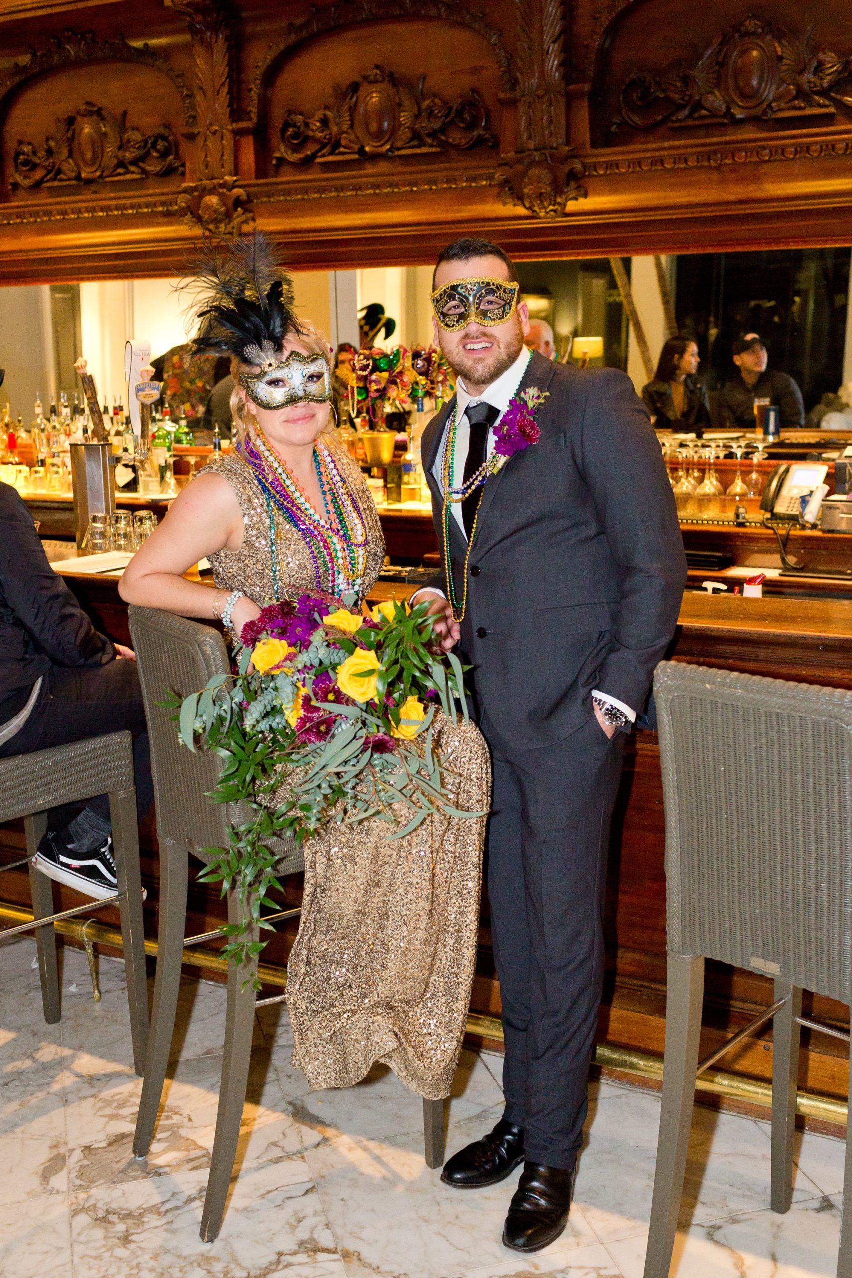 A bride and groom in masquerade masks at their Mardi Gras Galveston elopement.