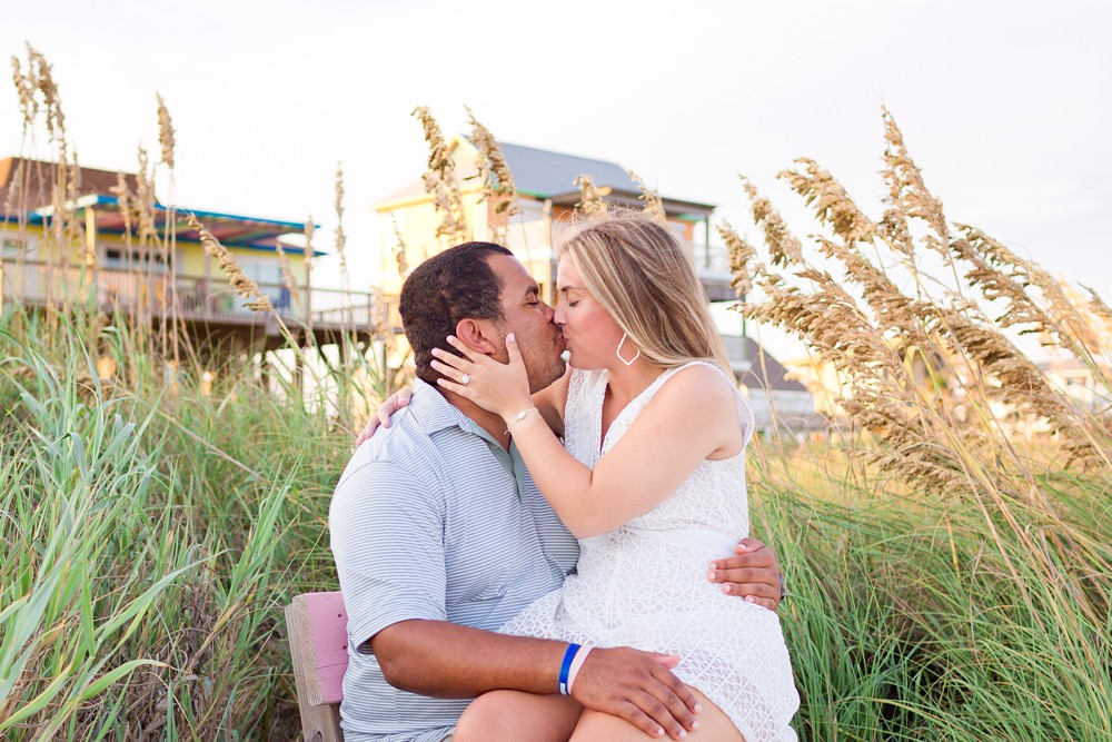 Couple taking engagement photos on Galveston Island beach