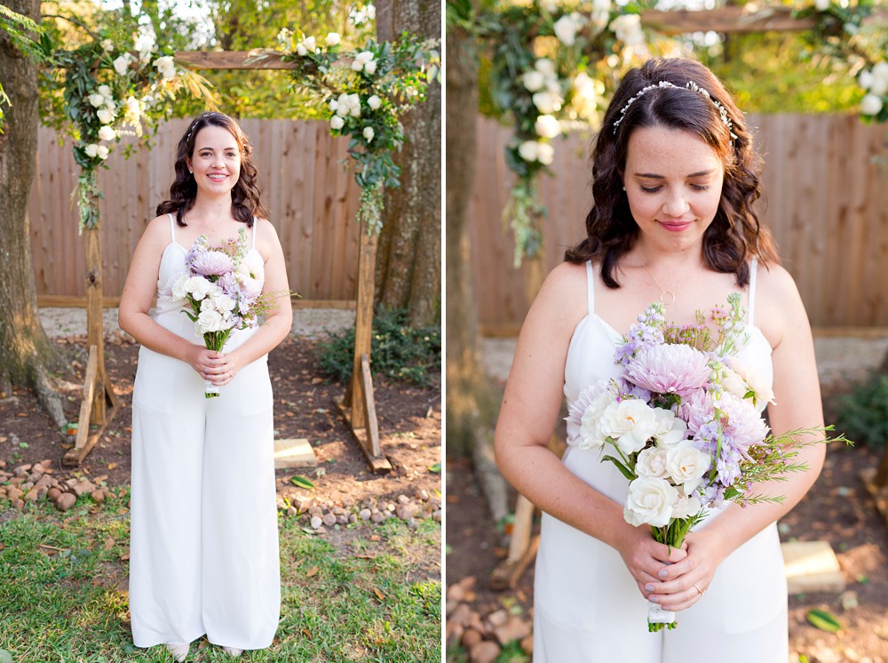 Bride in white jumpsuit with purple and white bouquet