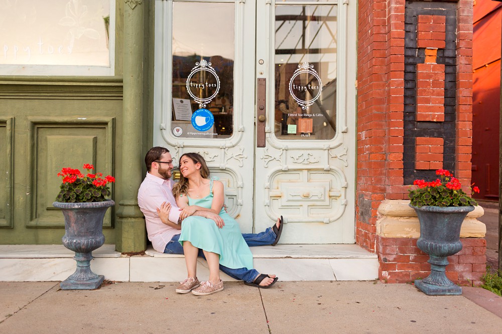 Couple sitting on a step at their Galveston historic district engagement session