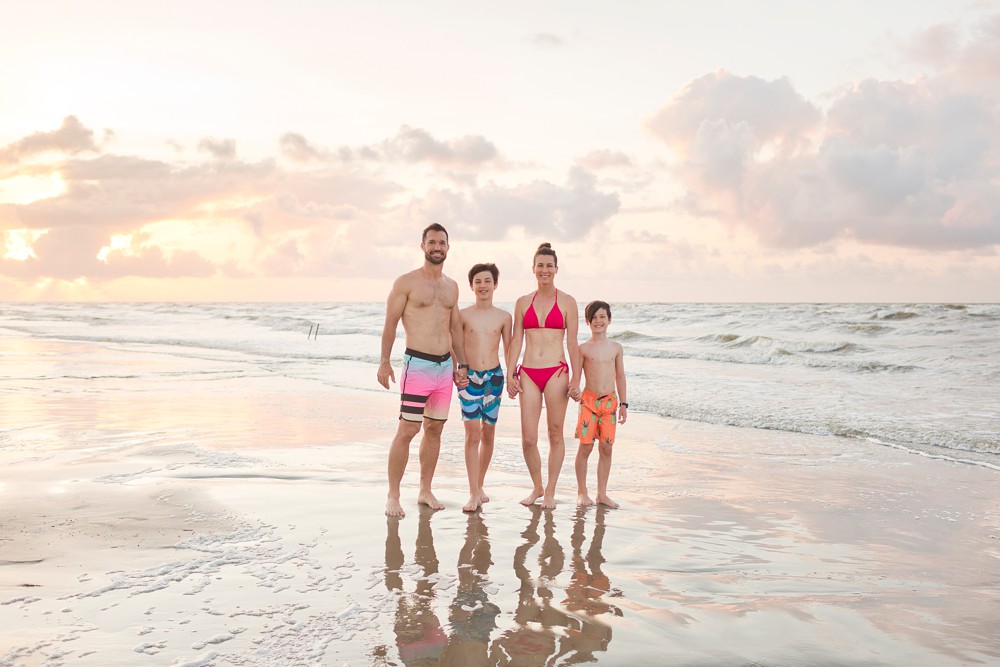Family on a Texas beach with the sunrise behind them