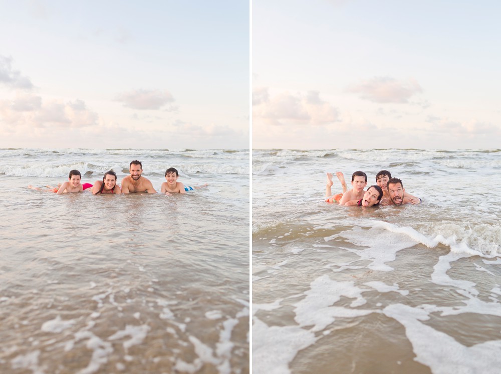 family laying in the ocean