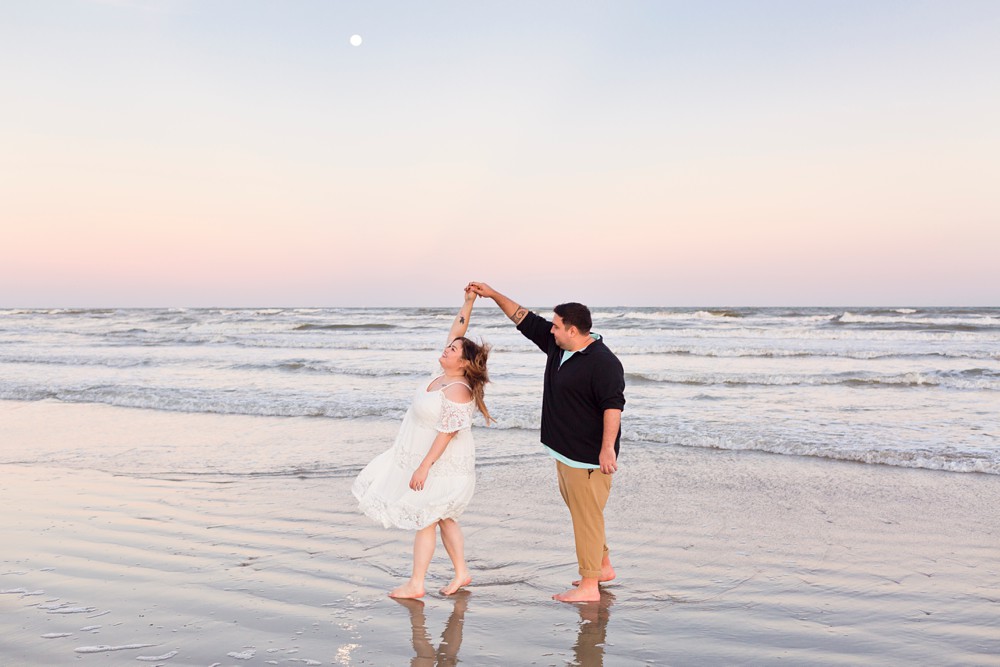 Couple dancing at their Galveston Beach sunset engagement session