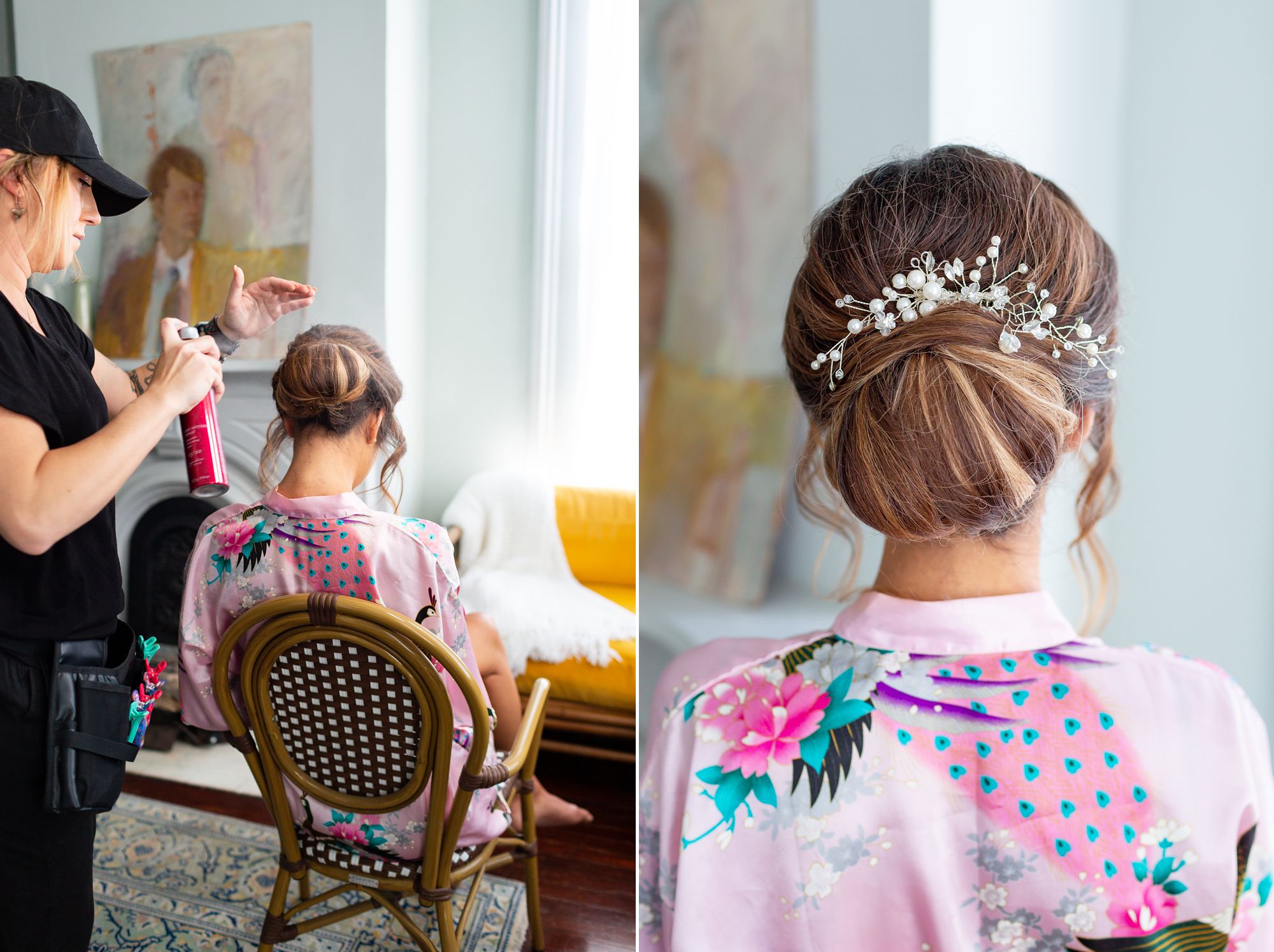 A hairstylist sprays a bride's hair with hairspray; the back of the bride's head with an updo embellished with a pearl and crystal comb.