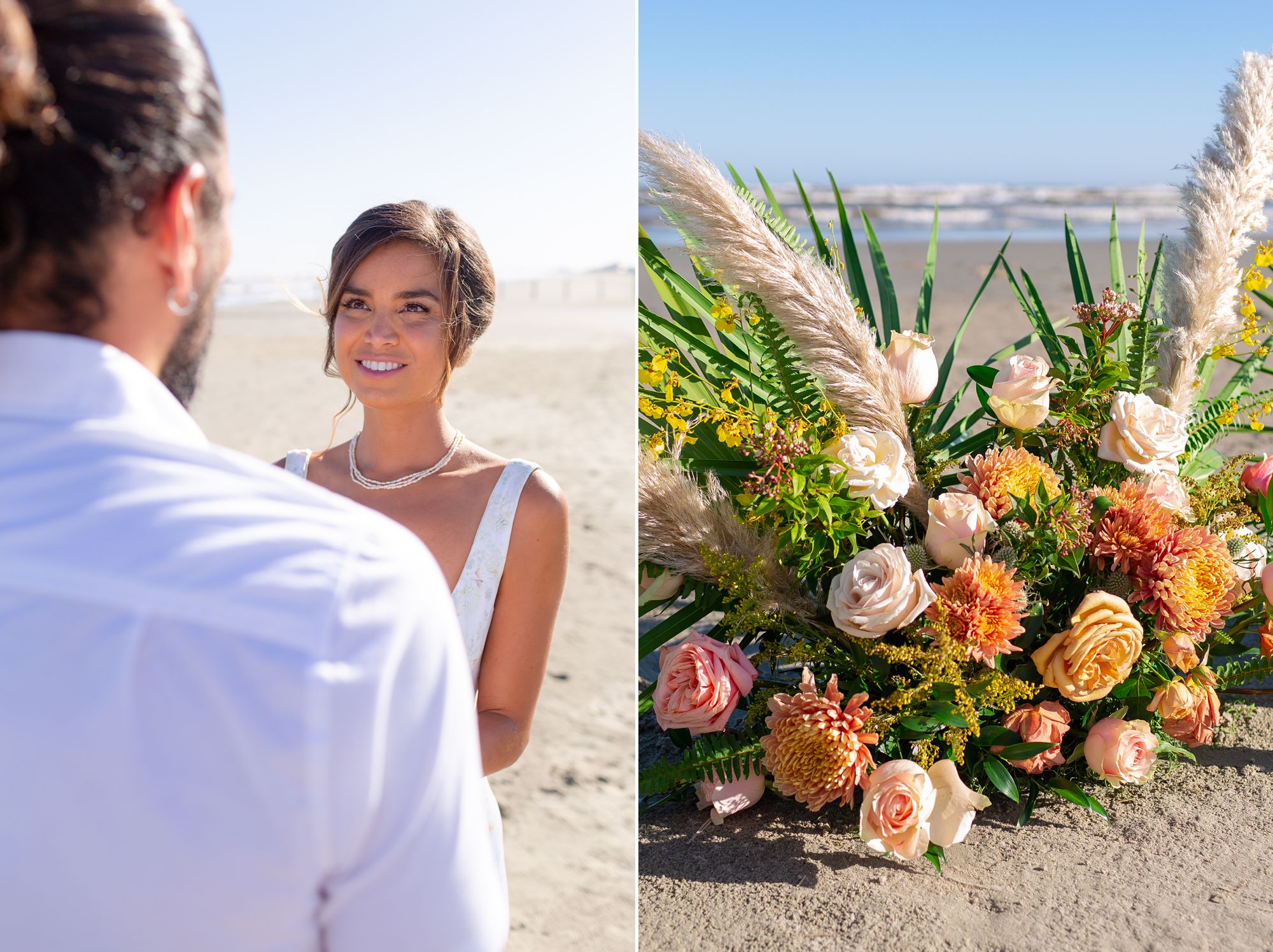 A bride and groom stand facing each other at their elopement ceremony; a large pink, orange and yellow flower arrangement with roses sits in the sand.