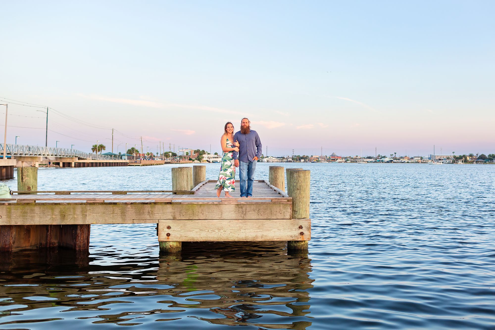 Couple on a boat dock at Lee and Joe Jamail Bay Park couple session in Galveston during sunset.