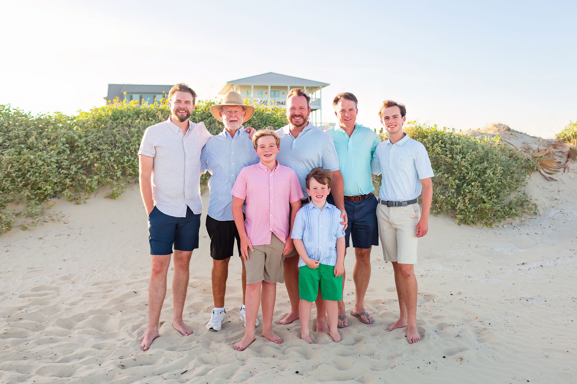 A grandfather stands with his sons, sons-in-law, and grandsons at a Crystal Beach Extended Family session in Texas.