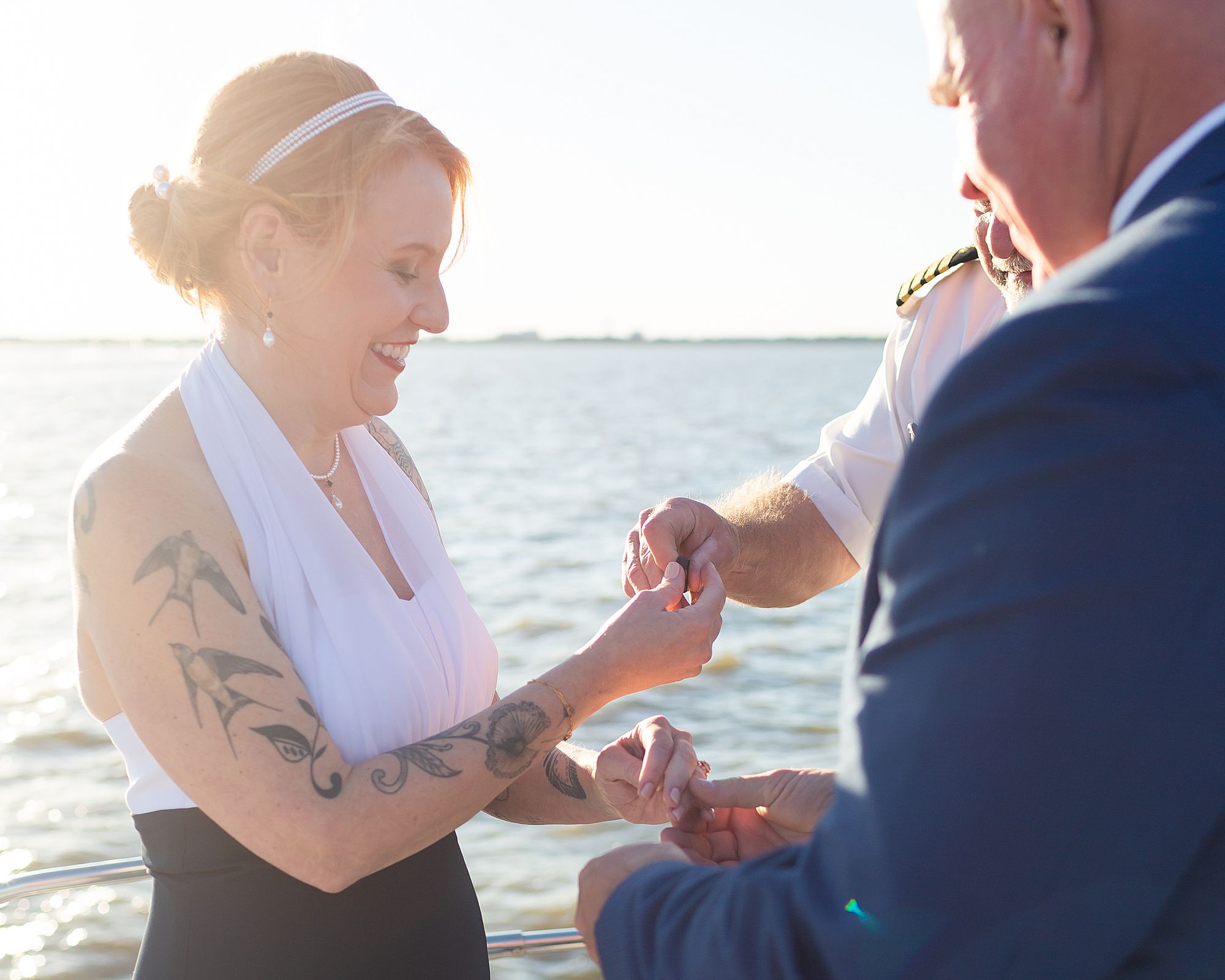 A bride take a ring from the officiant to place on her groom's hand.