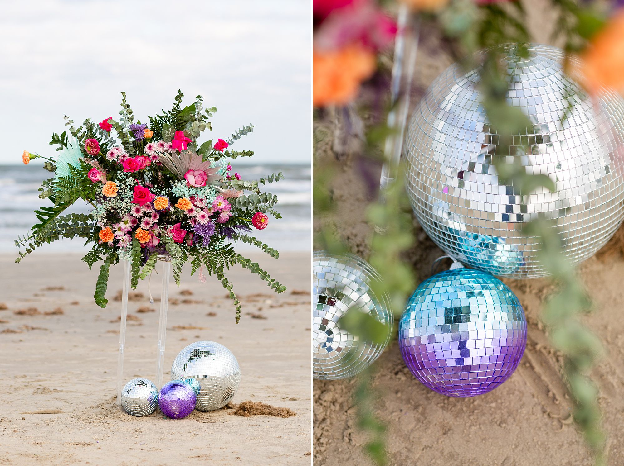 A pink, orange, purple, and turquoise floral display sits on top of a clear acrylic column on the beach, with silver and purple disco balls in the sand.
