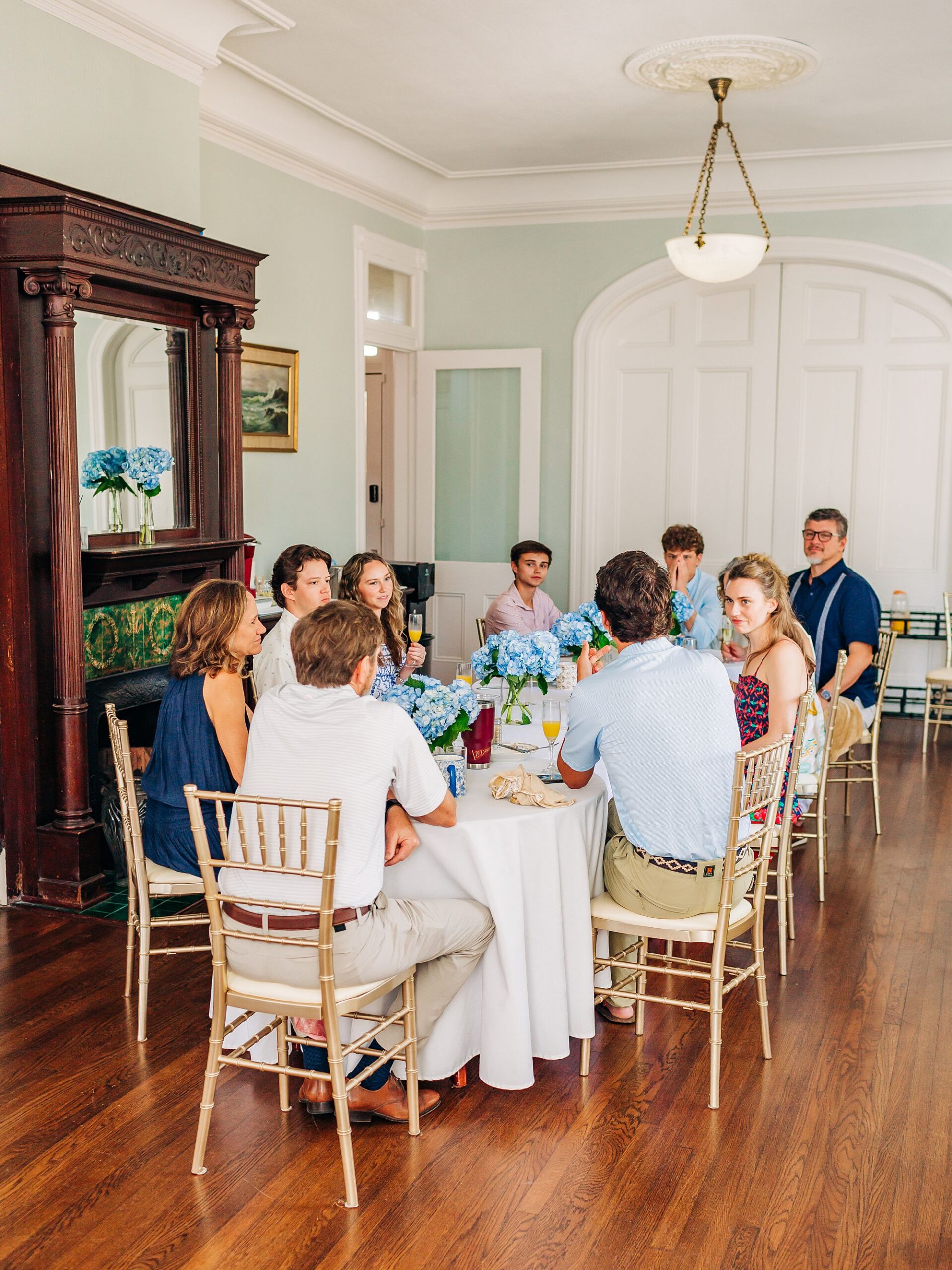 A newly engaged couple enjoy brunch at Carr Mansion with their families.